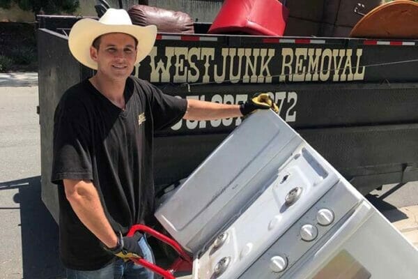 A man holding a large piece of junk.