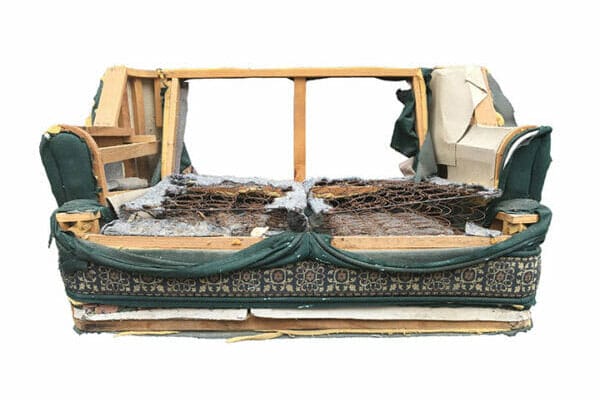 A wooden frame with a green cover and some fur on it